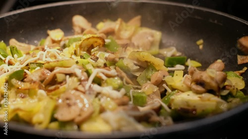 Mushrooms, leek, pepper and curgette being cooked in the pan