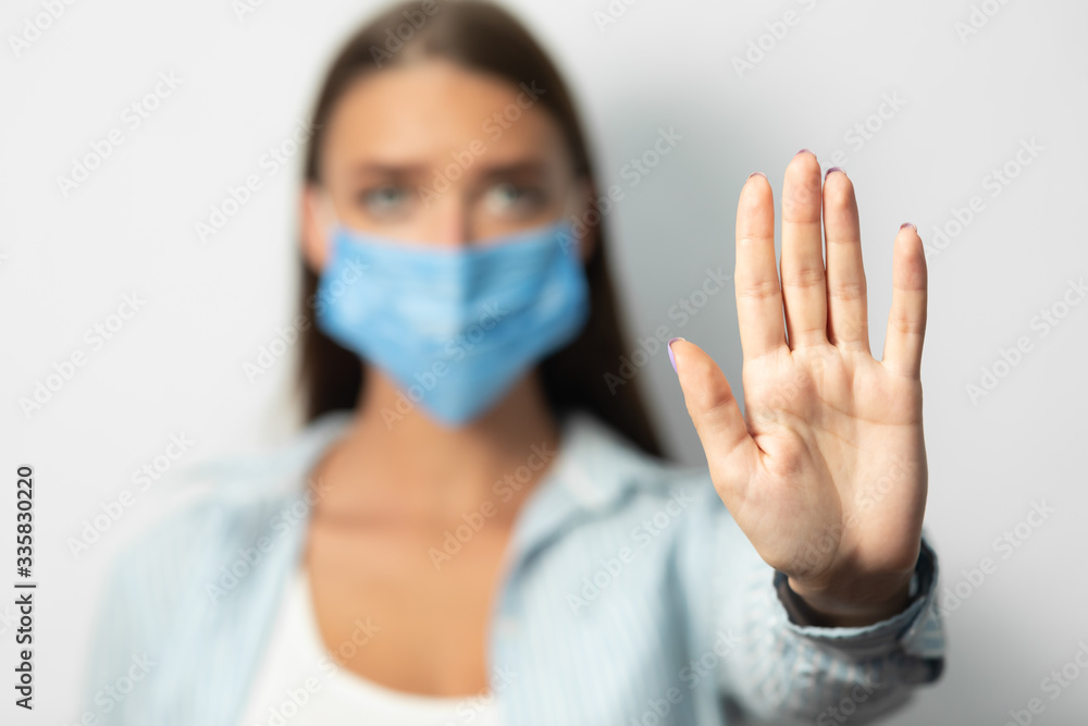 Girl In Mask Gesturing Stop Forbidding Something Over White Background Girl In Mask Gesturing Stop Forbidding Something Over White Background