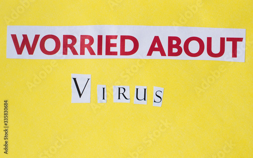 worried about virus inscription cut out on a yellow background, red letters 
