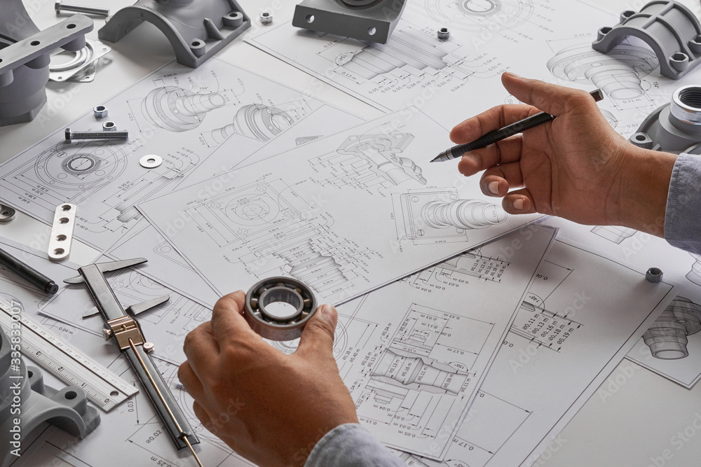 © Chaosamran_Studio - Engineer technician designing drawings mechanical parts engineering Engine.manufacturing factory Industry Industrial work project blueprints measuring bearings caliper tools