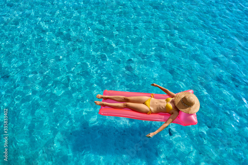 Woman relaxing on inflatable mat float