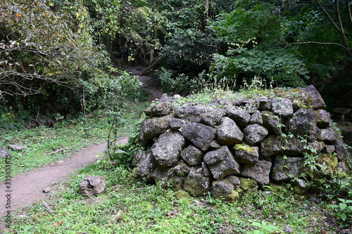 a stone wall next to a path