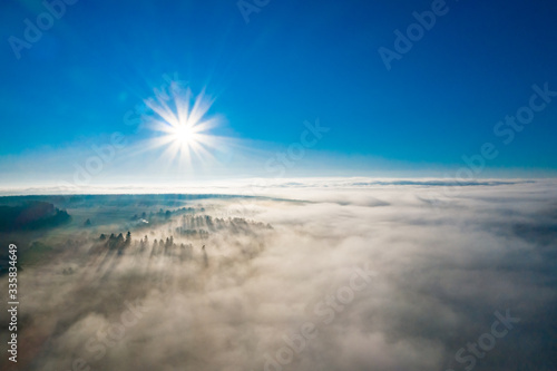 Wonderful foggy morning in the Ukrainian village on the Carpathian Mountains with sunshine