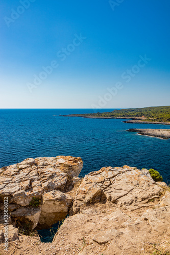 The wonderful bay of Porto Selvaggio. In Nard    Italy  Puglia  Salento. The view of the panorama from the top of the promontory. The blue sea to the horizon. The overhang from the rocky outcrop