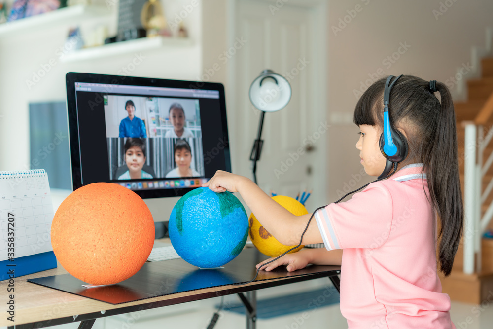 © ake1150 - Asian girl student live learning video conference with teacher and other classmates giving presentation, showing solar model project, Homeschooling and distance learning ,online ,education.