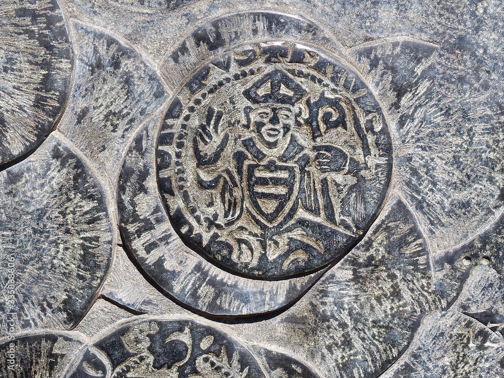 Historic coins of Florence in Italy seen on an outside wall of a church