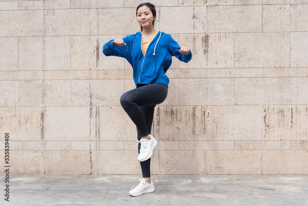 A young Asian woman is doing warm-up exercises A young Asian woman is doing warm-up exercises