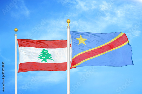 Lebanon and Congo Democratic Republic two flags on flagpoles and blue cloudy sky photo