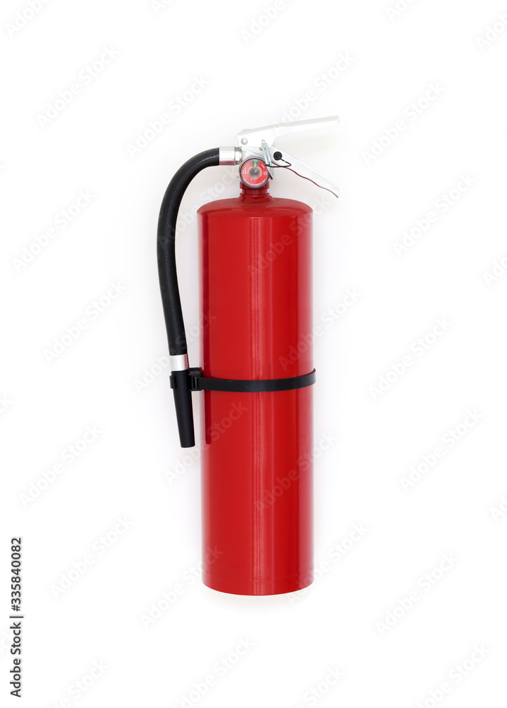 Red fire extinguisher is on white wall, close-up Red fire extinguisher is on white wall, close-up