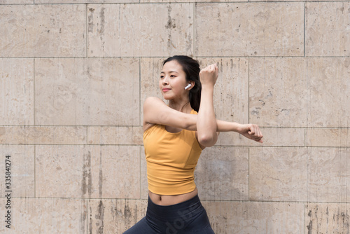 A young Asian woman is doing warm-up exercises