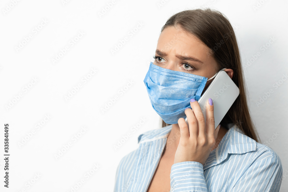 Woman Talking On Cellphone Over White Background, Wearing Protective Mask Woman Talking On Cellphone Over White Background, Wearing Protective Mask
