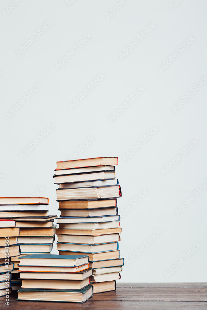 many stacks of educational books at home preparing for exams on a white background many stacks of educational books at home preparing for exams on a white background