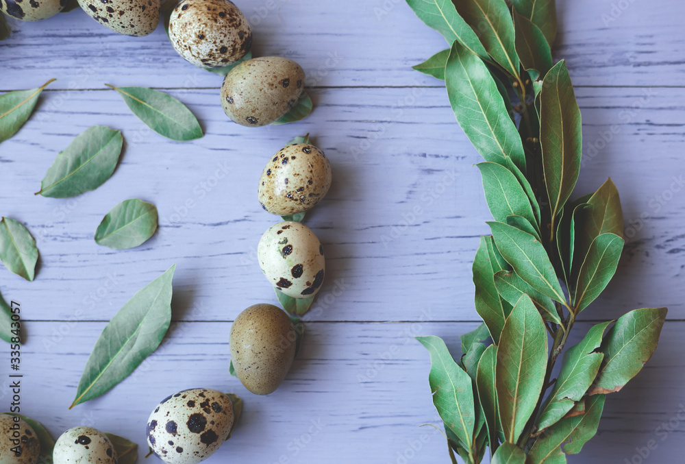 circle of quail eggs and leaves. happy easter.