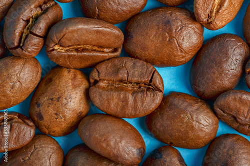 Coffee beans on a blue background macro closeup © Edhar