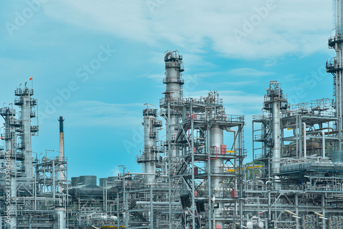 Oil and gas industrial, Oil refinery plant from industry, Refinery Oil storage tank and pipe line steel with blue sky background.