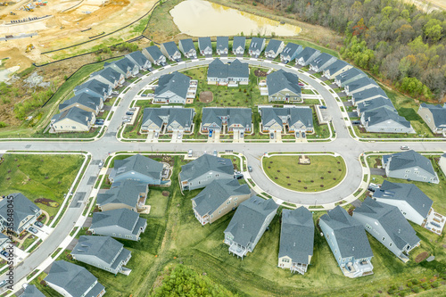 Aerial view of the geometrical curving American residential neighborhood, single family homes built close to each other by a cross street in Two Rivers Crofton Maryland