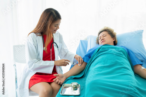 Asian doctor having checkup for a senior patient taken by soft focus technique