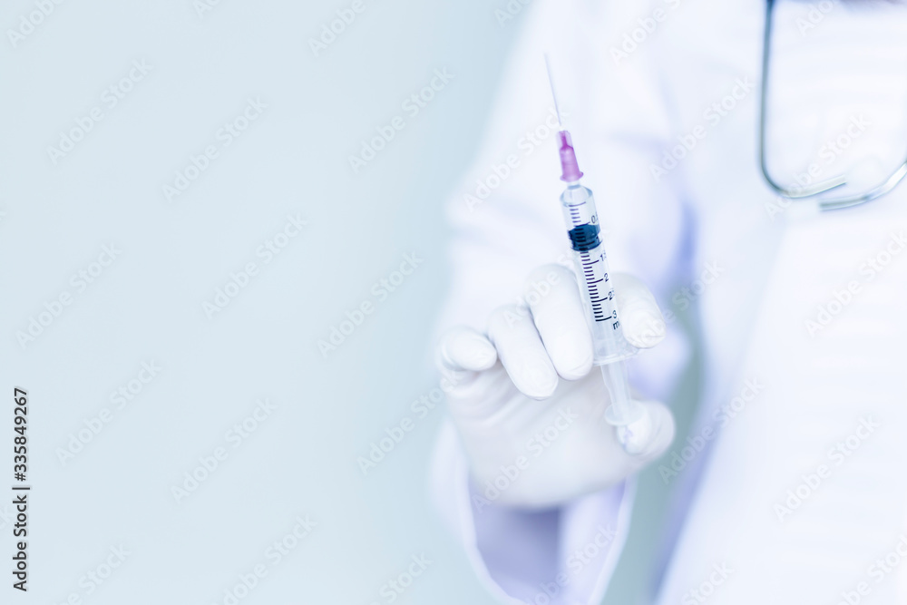 A female doctor with a syringe. A female doctor with a syringe.