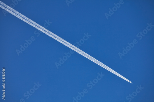plane in the sky with contrail