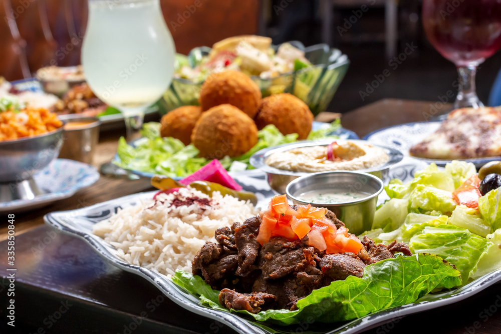 A view of a table full of several Mediterranean dishes, in a restaurant or kitchen setting. A view of a table full of several Mediterranean dishes, in a restaurant or kitchen setting.