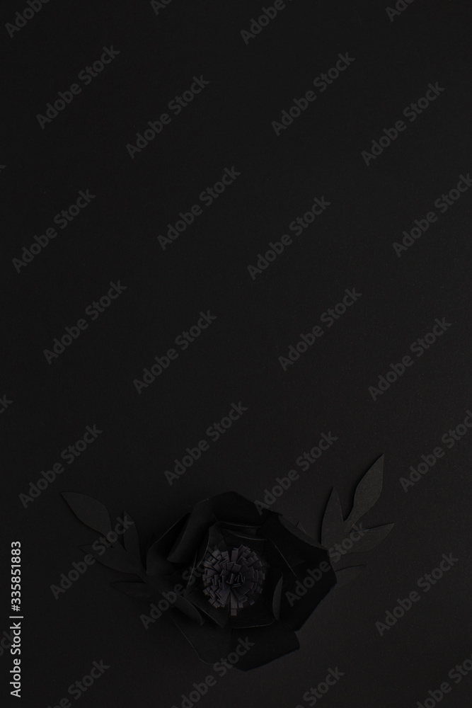 Fototapeta premium black background with a flower made of paper, top view