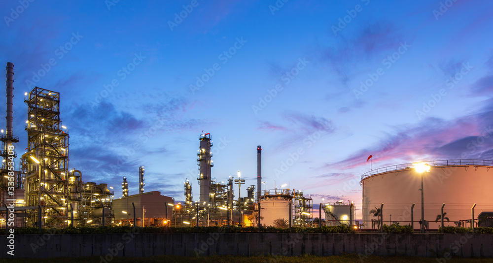 Industrial refinery and petrochemical plants, natural gas storage tanks in the background