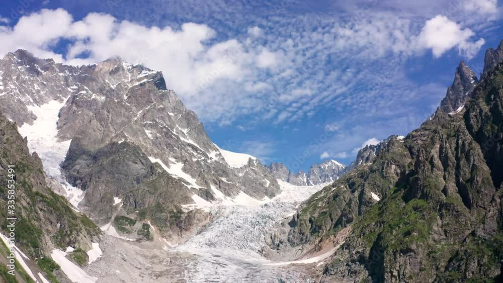 Caucasus Mountains on the border of Russia and Georgia. Chalaat Pass and Very beautiful view of the Chalaadi Glacier, Mount Ushba and Mestiachala river with background of clear blue sky. Caucasus Mountains on the border of Russia and Georgia. Chalaat Pass and Very beautiful view of the Chalaadi Glacier, Mount Ushba and Mestiachala river with background of clear blue sky.