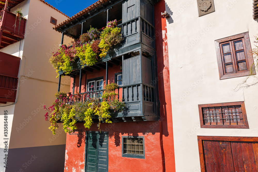 Naklejka premium Famous ancient colorful balconies decorated with flowers. Santa Cruz - capital city of the island of La Palma, Canary Islands, Spain.