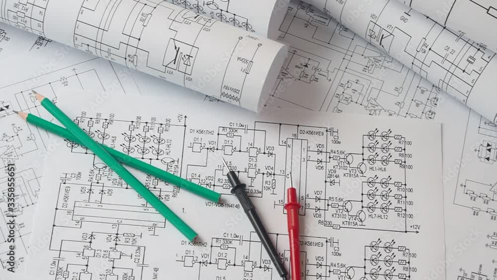 Electrical engineering drawings, digital multimeter and pencils. Electronics Engineer project. Electrical engineering drawings, digital multimeter and pencils. Electronics Engineer project.