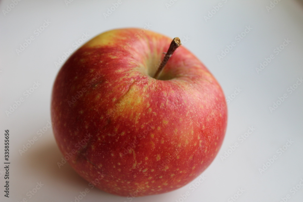 fruit food red Apple close up on a white light background with a place to insert text fruit food red Apple close up on a white light background with a place to insert text
