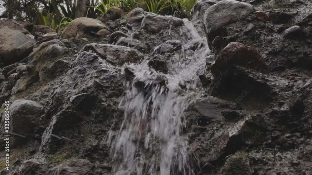 water is running trough big crack in basalt boulder water is running trough big crack in basalt boulder