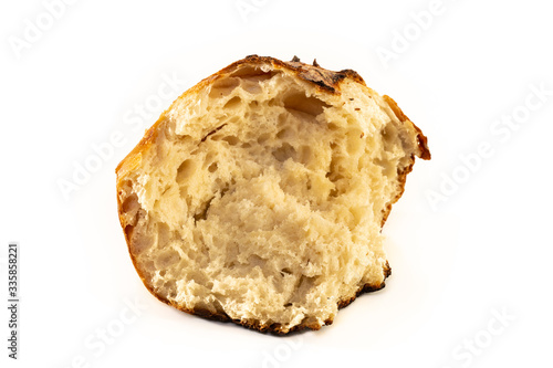 A homemade baked loaf of round artisan white sourdough bread isolated on white.