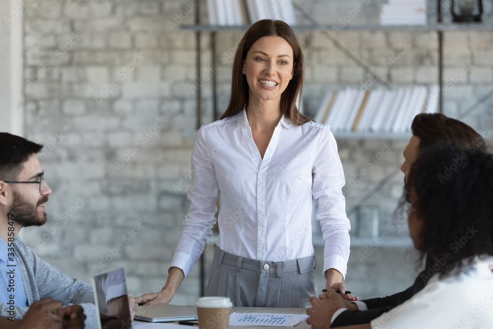 Happy businesswoman manager speaks in boardroom at meeting. Female ...