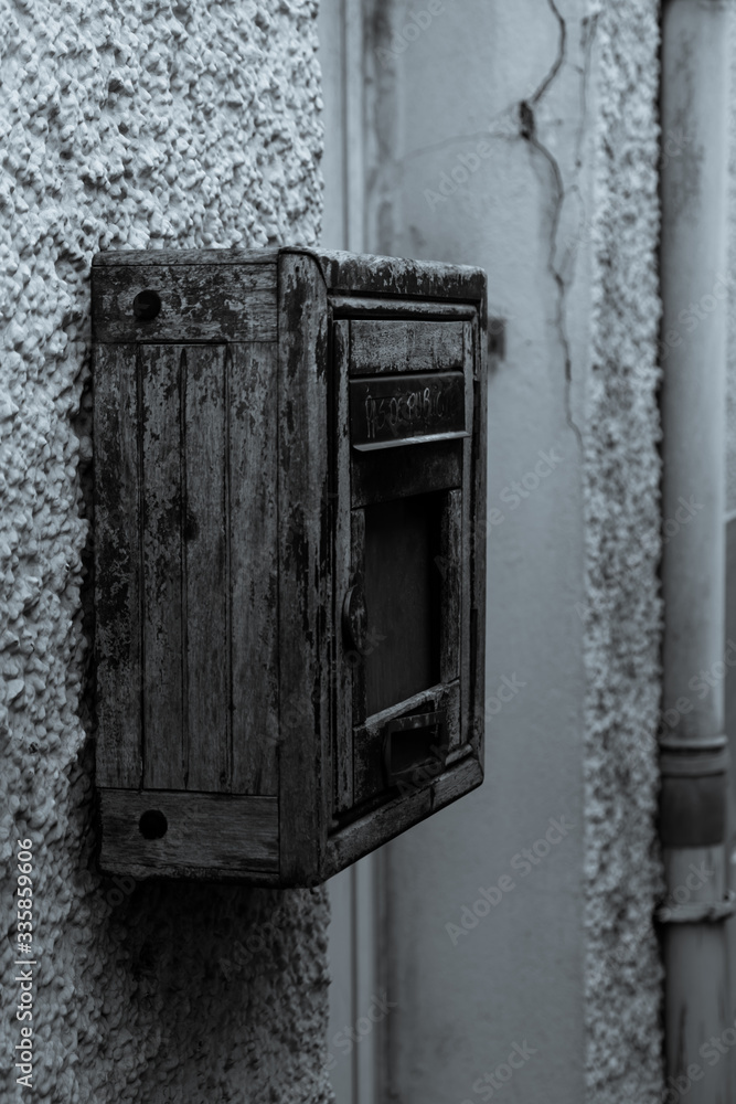 Black and white negative picture of an old mailbox. Street photography of an old wooden mailbox in France, Cholet - 2020. Black and white negative picture of an old mailbox. Street photography of an old wooden mailbox in France, Cholet - 2020.