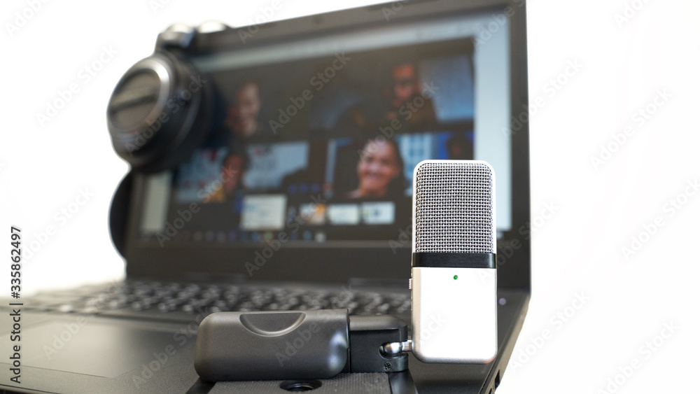 Using microphone and headphones with video conference on laptop for work from home white background