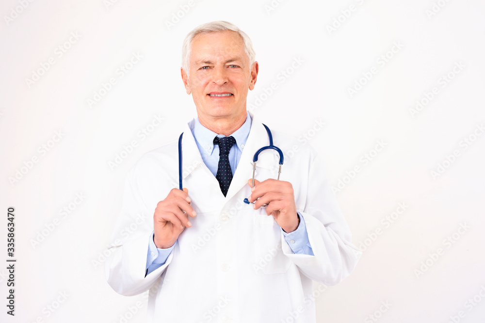 Senior male doctor studio portrait at isolated white background Senior male doctor studio portrait at isolated white background