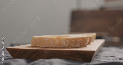 Fototapeta Naklejka Na Ścianę i Meble -  ciabatta slices on olive wood board closeup