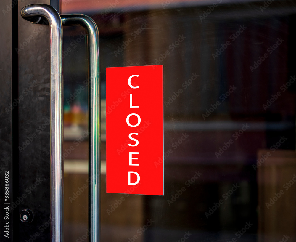  closed sign hanging outside a restaurant, store, office or other