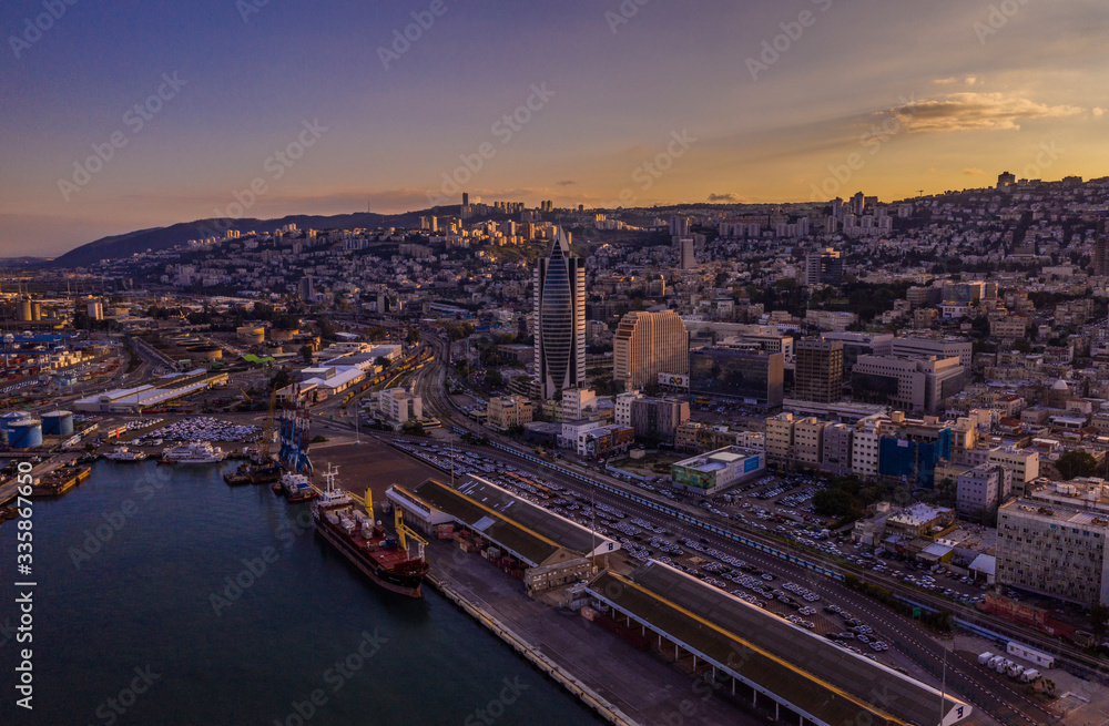 Haifa cargo harbor and cityscape at sunset aerial view
