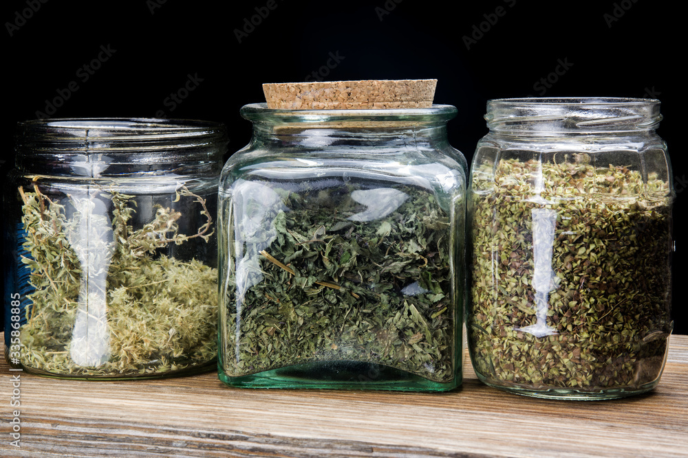 glass jars with ground dried aromatic plants glass jars with ground dried aromatic plants