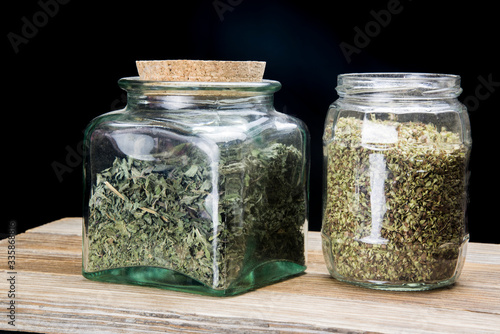 glass jars with ground dried aromatic plants
