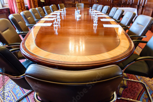 Принти на полотні Large wooden table in a board room with wood panelling, set up for a meeting