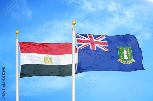 Egypt and Virgin Islands British two flags on flagpoles and blue cloudy sky photo