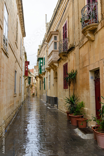 Narrow street in the walled city of Mdina, Malta, in heavy rain.
