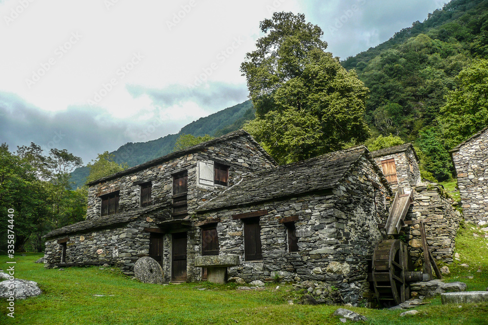 old stone mill in a green valley