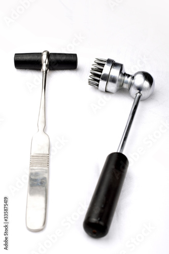 Old neurologist's malleus and  acupuncture hammers for chinese plum therapy on a white background.