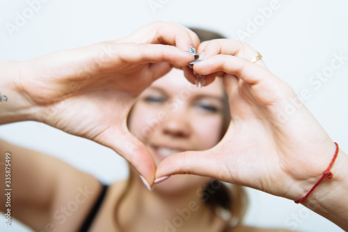 woman making a hand heart frame