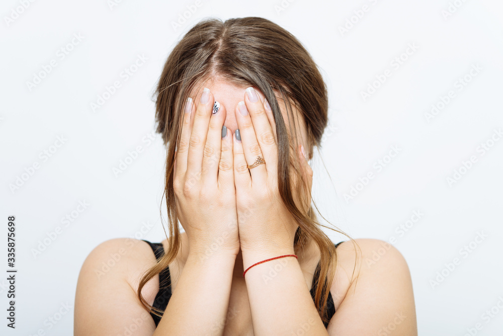 Woman covers his face by hand Woman covers his face by hand