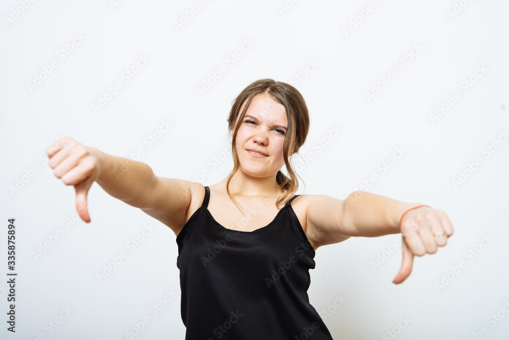 Woman showing a thumb down gesture Woman showing a thumb down gesture