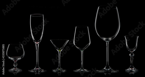 Five glass goblets on a black background
